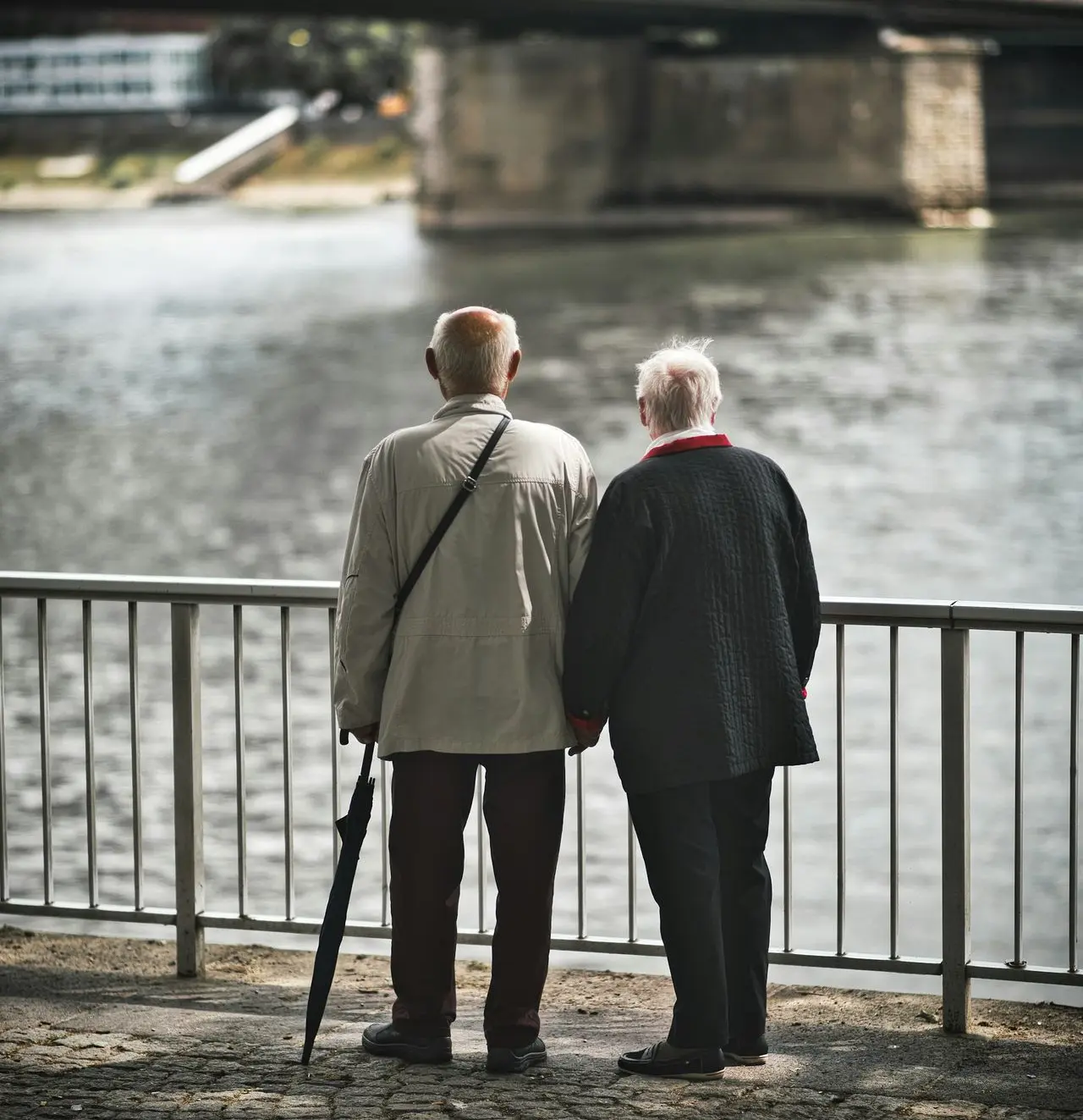 man in gray suit standing near body of water during daytime